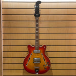 Electric guitar against a wooden panel background