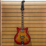 Electric guitar against a wooden panel background